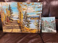 Both unframed paintings together for scale reference