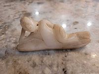 Left side view of reclining alabaster Buddha
