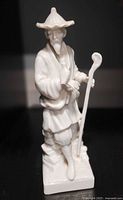 Front view of Fitz & Floyd blanc de chine fisherman figurine