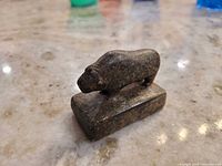 Side profile of soapstone muskox on base