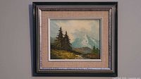 Full view of framed oil landscape painting on wall