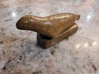 Side view of soapstone seal on base