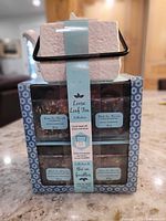 Boxed loose tea collection with teapot visible on top