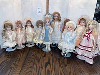 Front view of all ten dolls on stands