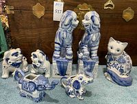 Group shot of all seven blue and white porcelain animal figures