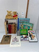 Entire lot showing two Pooh plush bears, row of antique books, contemporary picture books, DVD case