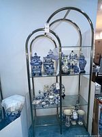 Full view of brass and glass shelf unit with items displayed (items not included)