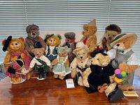 Group shot of 11 dressed bears on table