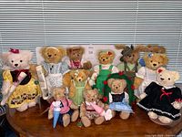 Front view of all twelve dressed bears and rabbit on table