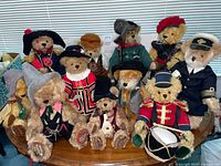 Group shot of all eleven Hermann bears on table, showing variety of costumes