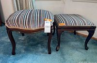 Both footstools side-by-side showing striped upholstery and cabriole legs