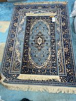 Both rugs stacked showing pattern and fringe