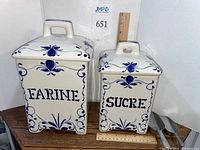 Front view of both canisters showing labels and ruler for scale