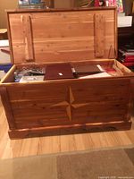 Cedar chest open showing cedar-lined interior and contents