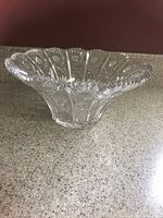 Side angled view showing flared shape, scalloped rim and paneled cut pattern