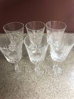 Group shot of all six crystal glasses showing pinwheel pattern and hexagonal bases