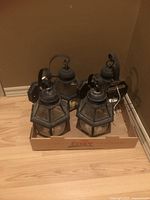 Four outdoor wall lanterns in box