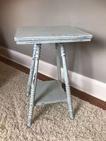 Front view of painted end table showing top and spindle legs