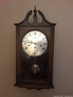 Front view of Schmeckenbecher wall clock showing full wooden case and glass door