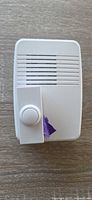 Front view of plug-in chime with push button taped to unit