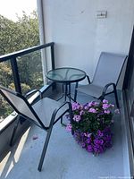 Full view of bistro set on balcony showing both chairs and table