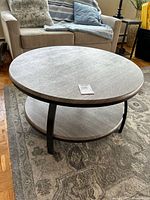 Full view of coffee table with two tiers and metal frame
