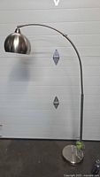 Full view of brushed silver arc floor lamp