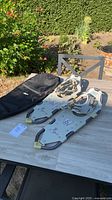 Pair of Atlas snowshoes and MEC bag on table