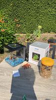 Aquarium, Top Fin box, jar of gravel, resin crab ornament on table