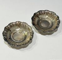 Top view of both 800 silver bowls showing pierced design and scalloped rims