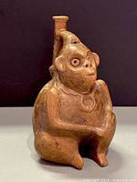 front view of terracotta monkey vessel with stirrup spout