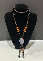 Full view of necklace on display bust showing overall design