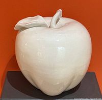 Front view of large white ceramic apple centerpiece