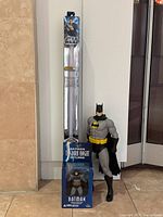 Lightsaber in packaging with loose 20-inch Batman figure