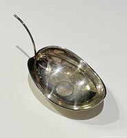 Top view of oval 800 silver leaf bowl showing interior, stem handle upright