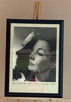 Full view of framed poster on easel