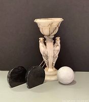 Front group shot of all items: stone eagle lamp, pair black marble bookends, white marble sphere
