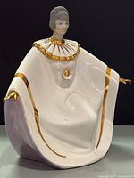 Front left view showing overall form, gold trim and facial detail