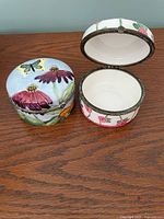 Both trinket boxes closed showing exterior artwork
