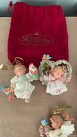 Five of the angel ornaments and red pouch shown