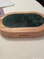 Top view of wooden board with marble insert and Sabatier logo