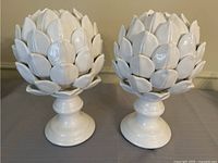 Front view of both ceramic artichoke figures