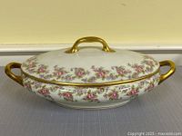 Full view of covered oval vegetable dish showing pattern and handles