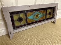 front view of stained glass panel showing full design in frame