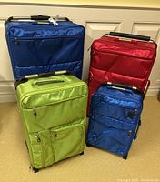 Group shot of three suitcases showing sizes and colors