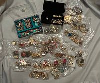 Overview of entire assortment of clip-on earrings in boxes and bags