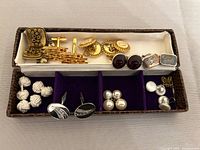 Overall view of all cufflinks, studs and tie tack in presentation box