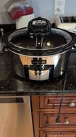 Front view of Crock-Pot with lid attached, cord visible