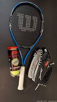Wilson racquet, Penn ball can, Rawlings glove grouped