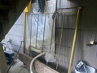 Brass headboard leaning against wall